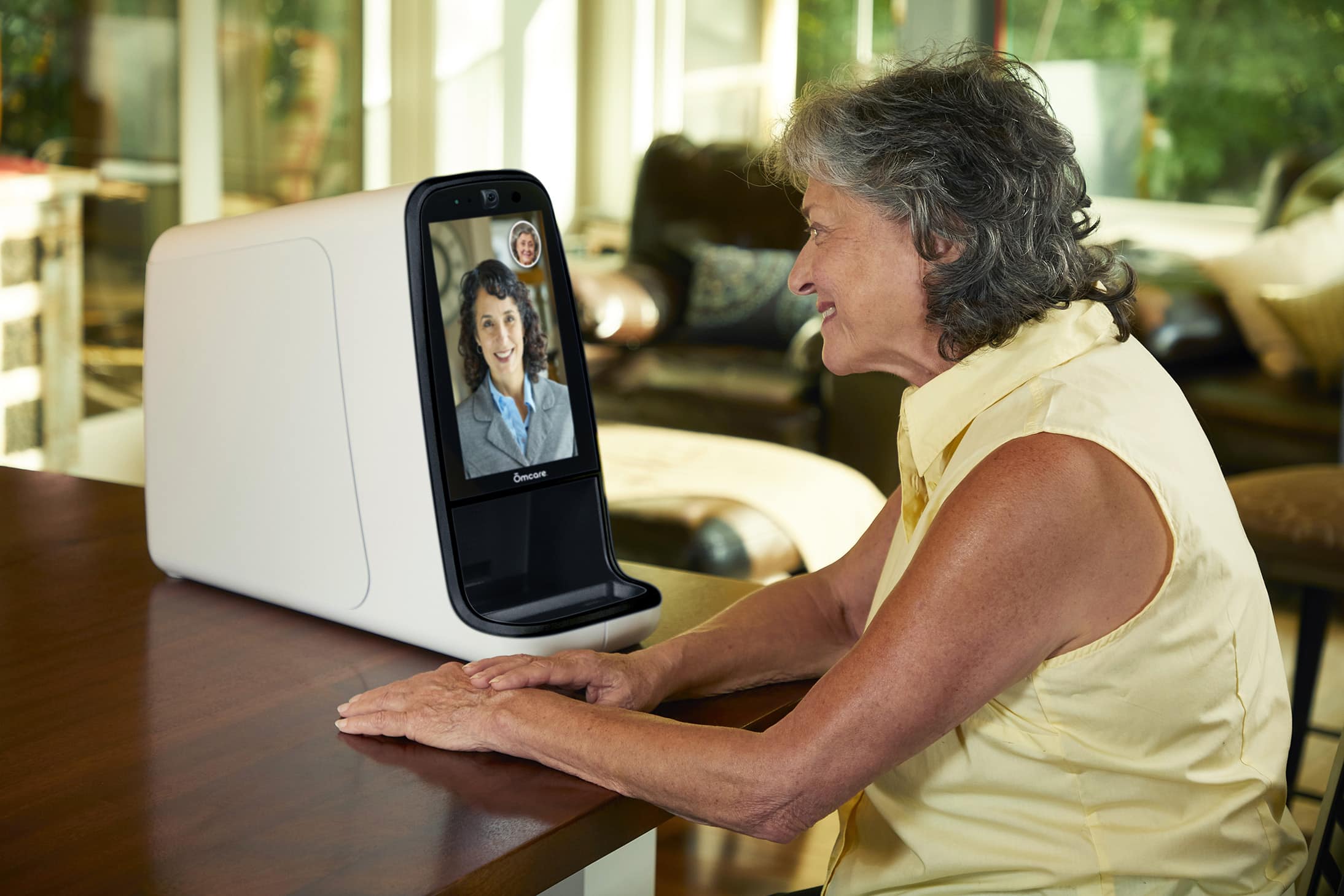 Two women using the Omcare Home Health Hub to connect.