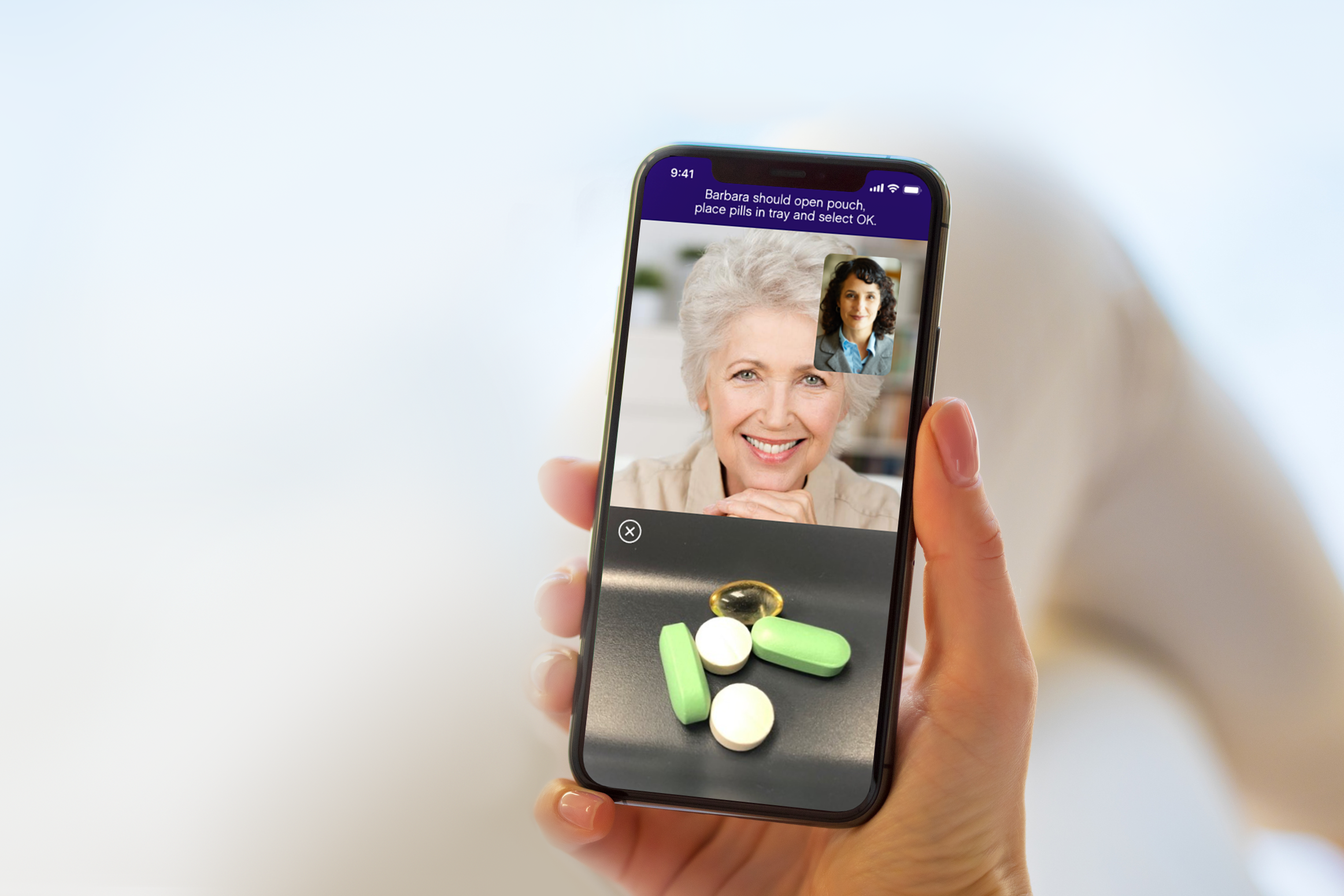 The Omcare mobile app displaying a picture in picture call and the pills in the pill tray.