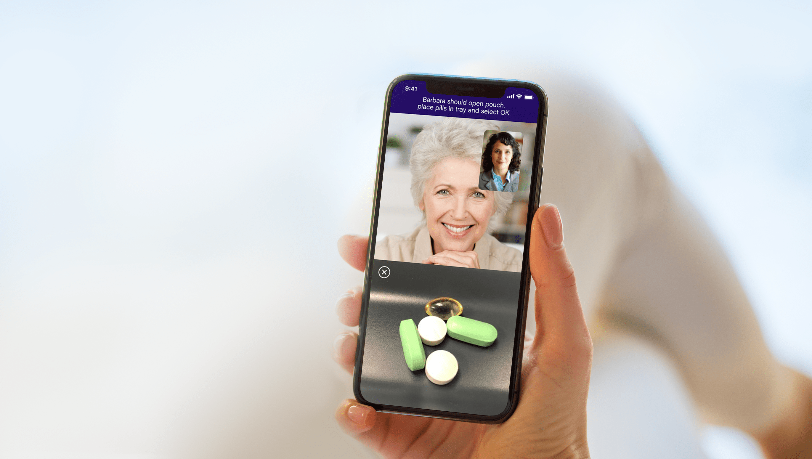 The Omcare mobile app displaying a picture in picture call and the pills in the pill tray.