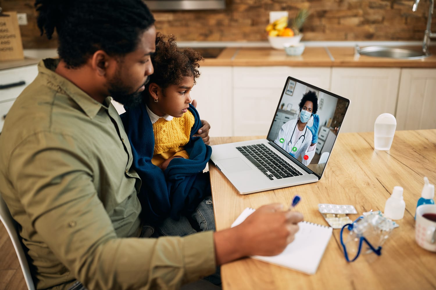 Father and daughter receiving telehealth care