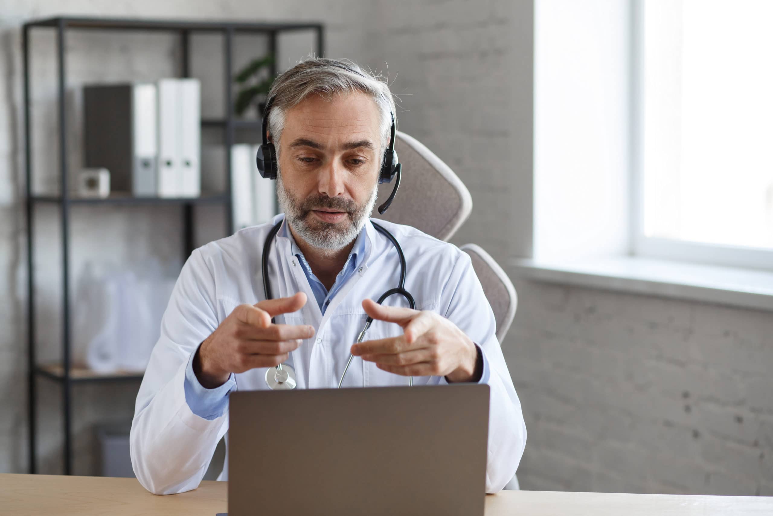 Adult male doctor providing telehealth services